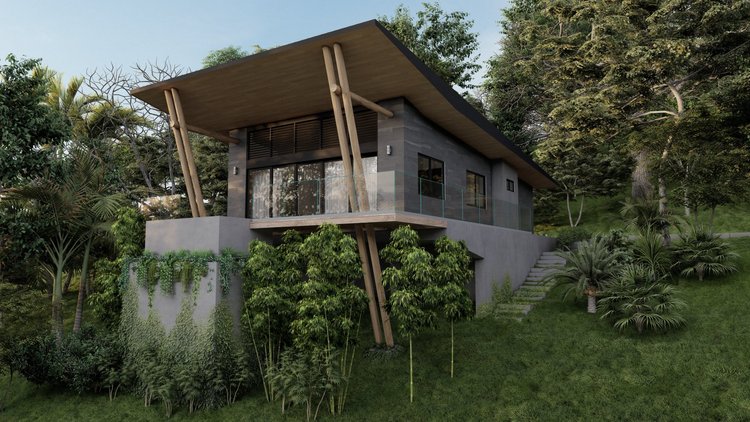 Modern house with large glass doors and balcony, elevated on concrete foundation, surrounded by lush green trees and plants, with steps leading up the hillside.
