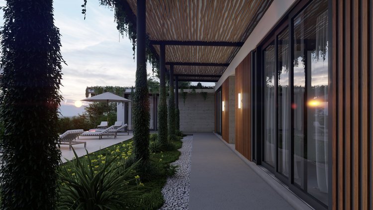 Modern house exterior patio with lounge chairs, umbrella, and garden at sunset.