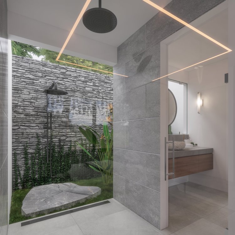 Modern bathroom with a glass-enclosed outdoor shower area with stone and greenery, adjacent to an indoors vanity with a large mirror.