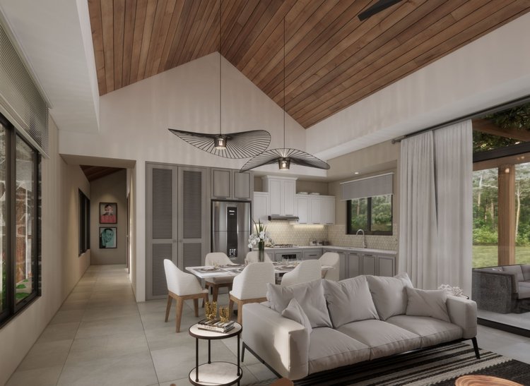 Modern open-concept living and kitchen area with vaulted wood ceiling, white walls, tiled floor, white sofa, dining table with six chairs, and large windows with curtains showing outdoor greenery.