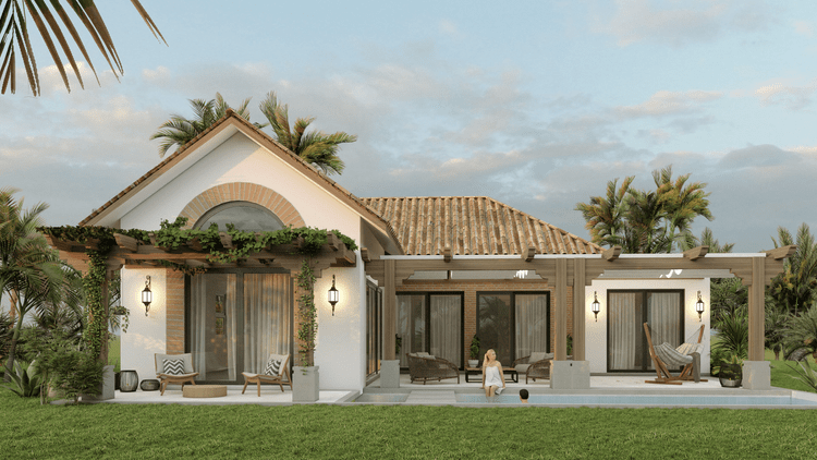 Exterior view of a modern house with a tiled roof, white walls, and large glass sliding doors. The house has a patio with outdoor seating, a pergola with climbing plants, and a swimming pool with two people relaxing in and around it. Tall palm trees 