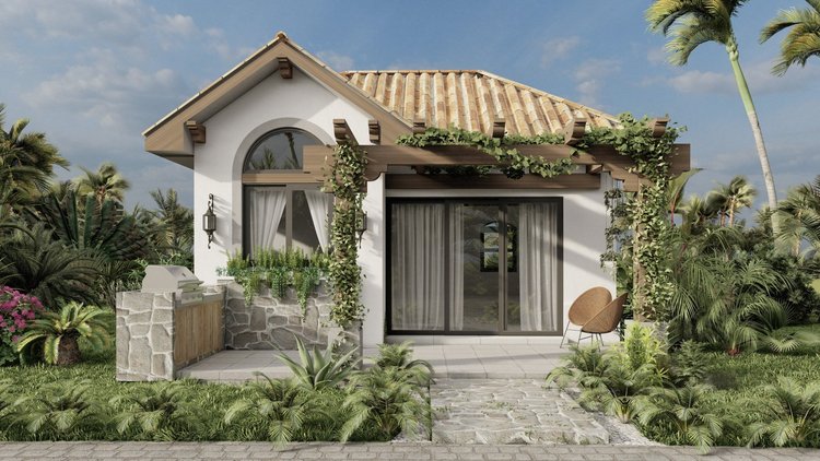 Modern house with a white exterior, tiled roof, and large sliding glass doors, surrounded by lush tropical plants and palm trees, with outdoor seating and decorative lighting.