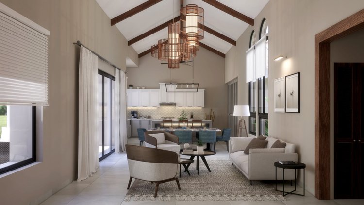 Living room with beige walls, white sofa, armchair, black side table, patterned rug, window blinds, and kitchen in the background with white cabinets and dining area.