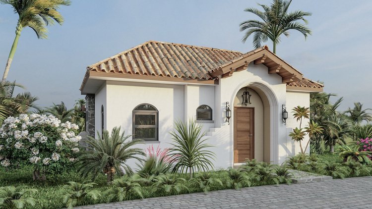Small white house with a tiled roof, arched doorway, and tropical plants in front.