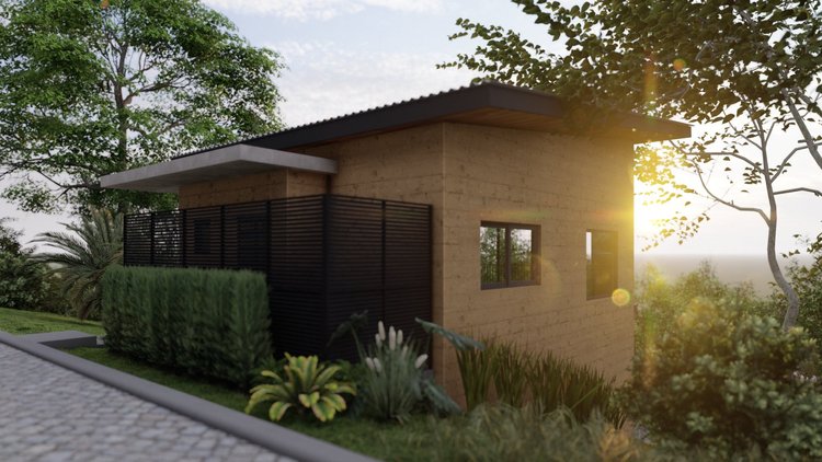 Modern house with tan brick exterior, black window frames, and a black privacy fence, surrounded by trees and plants with sunlight shining in the background.