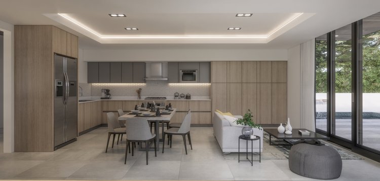 Modern open-concept kitchen and living room with wood and gray cabinetry, dining table, gray chairs, white sofa, black coffee table, large sliding glass doors, and greenery outside.