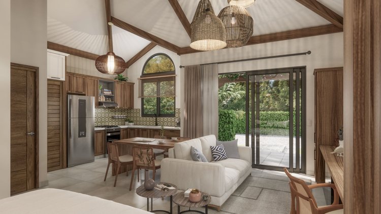 Interior of a living room and kitchen area with wooden accents, a white sofa, dining table with chairs, and large sliding glass door leading to an outdoor patio with greenery.