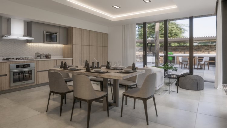 Modern, open-concept kitchen and dining area with a view of a patio outdoors. The kitchen has light wood cabinetry, a stainless steel oven, and a microwave. The dining table is set with napkins, plates, and glassware, surrounded by beige chairs. Larg